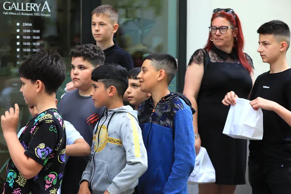 A Sugó Tamburazenekar gyerektagjai ételes csomagokkal várakoznak az országgyűlési fellépés előtt.