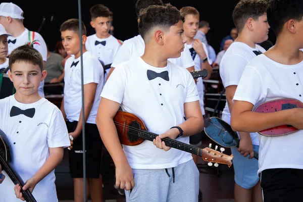 A SUGO fiatal tamburásai hangszereikkel várakoznak a margitszigeti főpróbán, közvetlenül a színpadi beállás előtt.